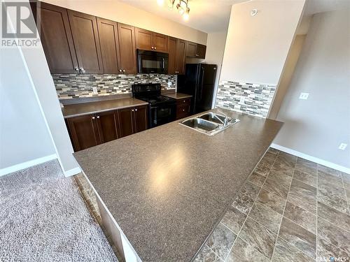 409 820 5Th Street, Weyburn, SK - Indoor Photo Showing Kitchen With Double Sink