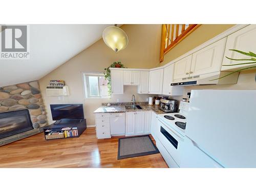 400 Riverside Way Unit# 439, Fernie, BC - Indoor Photo Showing Kitchen With Fireplace With Double Sink