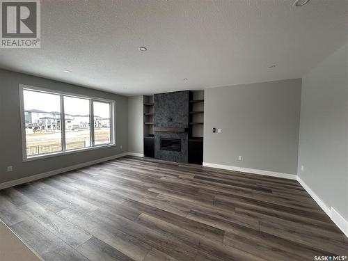 5218 E Green Crescent, Regina, SK - Indoor Photo Showing Living Room With Fireplace