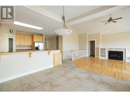 7760 Okanagan Landing Road Unit# 20, Vernon, BC - Indoor Photo Showing Kitchen With Fireplace