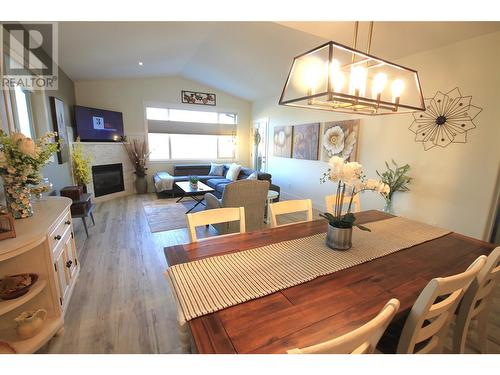 1040 Mt Revelstoke Place Unit# 33, Vernon, BC - Indoor Photo Showing Dining Room With Fireplace