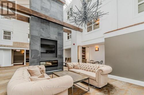 54-304 - 1235 Deerhurst Drive, Huntsville, ON - Indoor Photo Showing Living Room With Fireplace