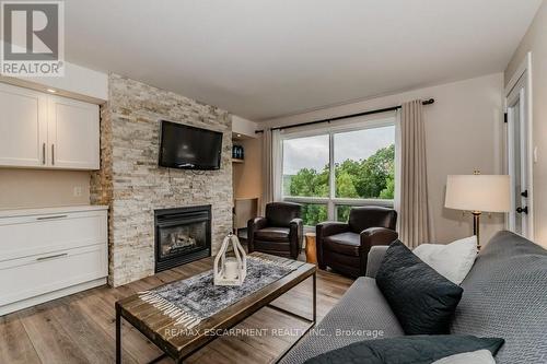 54-304 - 1235 Deerhurst Drive, Huntsville, ON - Indoor Photo Showing Living Room With Fireplace