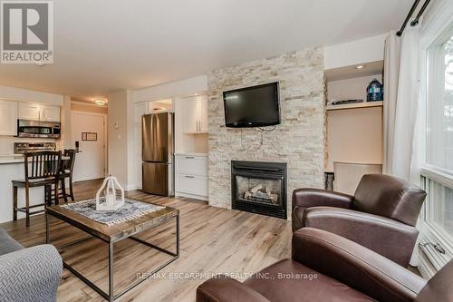 54-304 - 1235 Deerhurst Drive, Huntsville, ON - Indoor Photo Showing Living Room With Fireplace