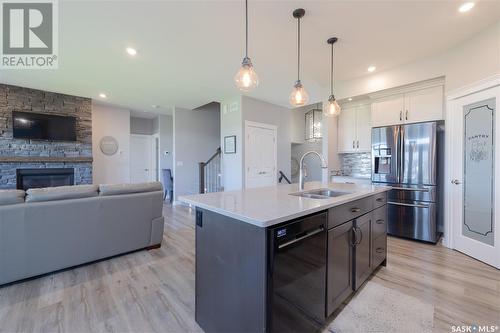 284 Cowan Crescent, Martensville, SK - Indoor Photo Showing Kitchen With Fireplace With Double Sink With Upgraded Kitchen