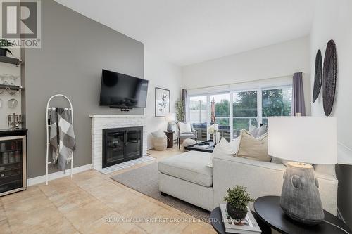 9 - 4 Paradise Boulevard, Ramara (Brechin), ON - Indoor Photo Showing Living Room With Fireplace