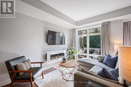 105 - 2 Dunsheath Way, Markham (Cornell), ON - Indoor Photo Showing Living Room With Fireplace