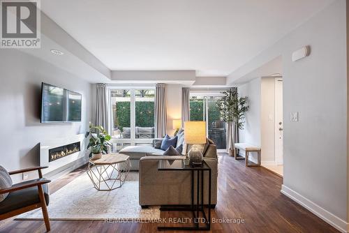 105 - 2 Dunsheath Way, Markham (Cornell), ON - Indoor Photo Showing Living Room With Fireplace