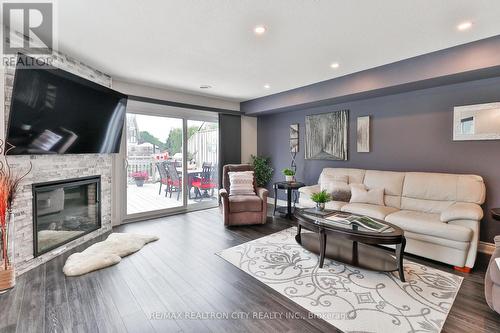 7 - 24 Laguna Parkway, Ramara (Brechin), ON - Indoor Photo Showing Living Room With Fireplace