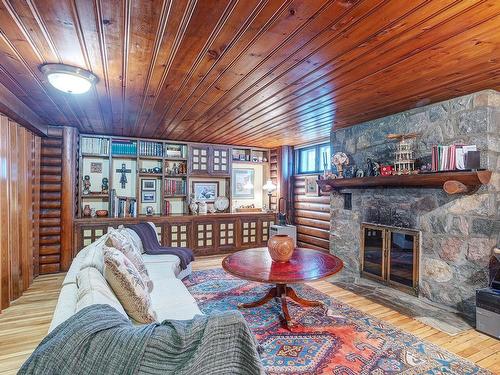 Family room - 5587 Ch. Queen-Mary, Hampstead, QC - Indoor Photo Showing Living Room With Fireplace