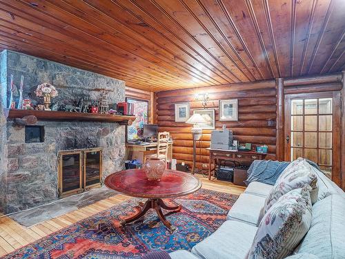 Family room - 5587 Ch. Queen-Mary, Hampstead, QC - Indoor Photo Showing Living Room With Fireplace