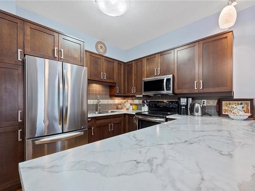 101-6310 Mcrobb Ave, Nanaimo, BC - Indoor Photo Showing Kitchen With Stainless Steel Kitchen