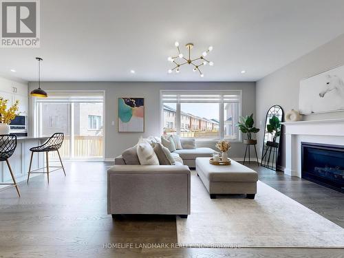 1281 Whitney Terrace, Milton (Ford), ON - Indoor Photo Showing Living Room With Fireplace