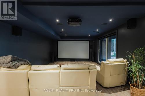 Theater with 100 inch screen with walk out to yard - 45 Blackburn Crescent, Middlesex Centre (Kilworth), ON - Indoor Photo Showing Laundry Room