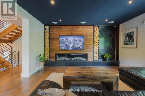 Custom back lit wall  with 70 inch fireplace - 45 Blackburn Crescent, Middlesex Centre (Kilworth), ON - Indoor Photo Showing Living Room With Fireplace