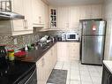 209 - 120 Dundalk Drive, Toronto (Dorset Park), ON  - Indoor Photo Showing Kitchen With Double Sink 