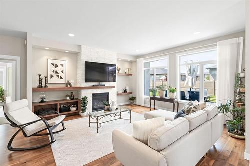 10 Southdown Lane, Headingley, MB - Indoor Photo Showing Living Room With Fireplace