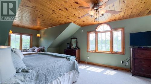 Primary bedroom with dormer window, sitting area and balcony overlooking the lake. - 46 Bell Drive, Huron-Kinloss, ON - Indoor Photo Showing Bedroom