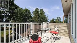 Primary suite balcony overlooks the lake. - 