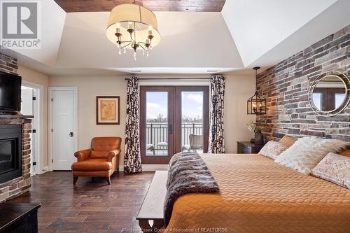 8748 Riverside Drive East, Windsor, ON - Indoor Photo Showing Bedroom With Fireplace