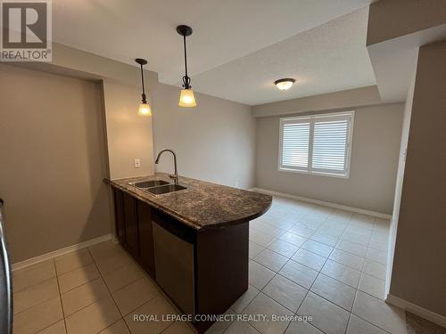 106 - 136 Aspen Springs Drive, Clarington (Bowmanville), ON - Indoor Photo Showing Kitchen With Double Sink