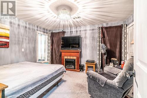 7 Gilson Street, Kawartha Lakes (Little Britain), ON - Indoor Photo Showing Bedroom With Fireplace