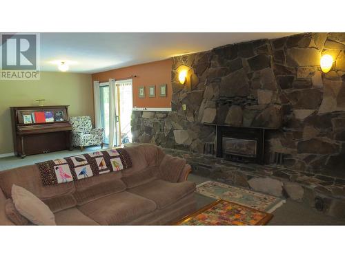 229 S Grosz Road, Quesnel, BC - Indoor Photo Showing Living Room With Fireplace