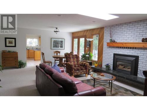 229 S Grosz Road, Quesnel, BC - Indoor Photo Showing Living Room With Fireplace