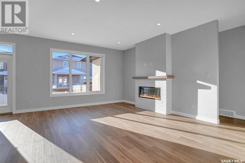 1617 Maple Rose Crescent N, Regina, SK - Indoor Photo Showing Living Room With Fireplace