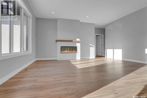 1617 Maple Rose Crescent N, Regina, SK - Indoor Photo Showing Living Room With Fireplace