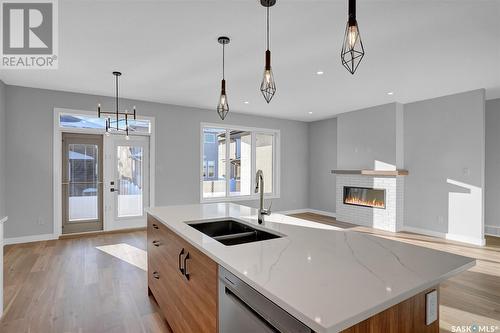 1617 Maple Rose Crescent N, Regina, SK - Indoor Photo Showing Kitchen With Fireplace With Double Sink