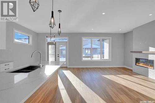 1617 Maple Rose Crescent N, Regina, SK - Indoor Photo Showing Kitchen With Fireplace With Double Sink