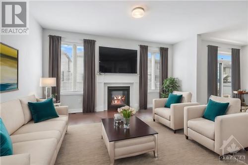 Staged family room with gas fireplace - 127 Alamo Street, Ottawa, ON - Indoor Photo Showing Living Room With Fireplace