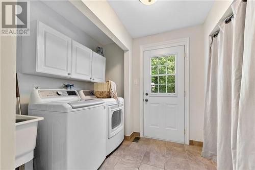 Main floor laundry with back yard access. - 132 Manion Road, Carp, ON - Indoor Photo Showing Laundry Room