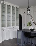 Floor-to-Ceiling cabinetry w/ reeded-glass doors - 