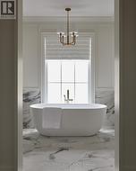 Primary ensuite w/ chair rail heigh porcelain tile - 