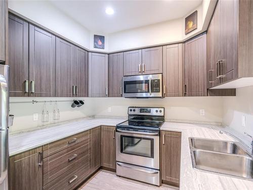 105-4960 Songbird Pl, Nanaimo, BC - Indoor Photo Showing Kitchen With Stainless Steel Kitchen With Double Sink With Upgraded Kitchen