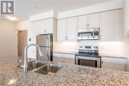 301 - 3028 Creekshore Common, Oakville, ON - Indoor Photo Showing Kitchen With Stainless Steel Kitchen With Double Sink With Upgraded Kitchen