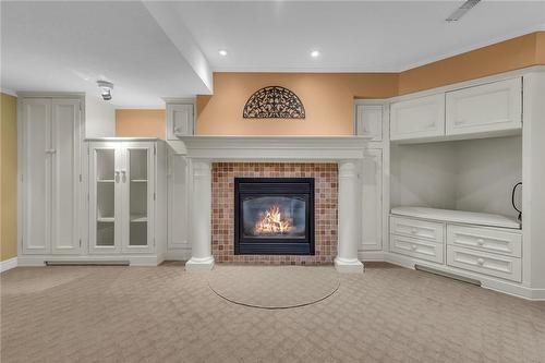 Family room with gas fireplace and built in cupboards - 190 Annabelle Street, Hamilton, ON - Indoor With Fireplace