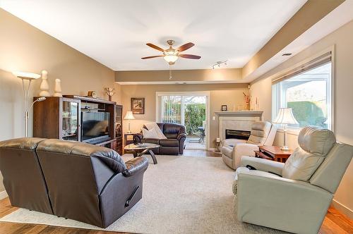 102-2300 Benvoulin Road, Kelowna, BC - Indoor Photo Showing Living Room With Fireplace