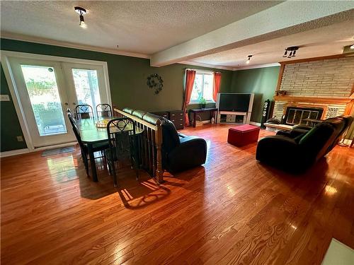 Lower 3rd level Dining room and Family room with cozy wood burning fire place and a walk out to your back yard oasis perfect for entertaining or just relaxing - 16 Flamingo Drive, Hamilton, ON - Indoor With Fireplace