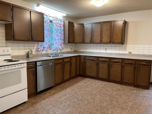 63 1St Street E, Swan River, MB - Indoor Photo Showing Kitchen With Double Sink