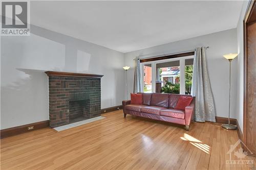 Formal Living Room with Wood Fireplace! - 62 Lees Avenue, Ottawa, ON - Indoor Photo Showing Living Room With Fireplace