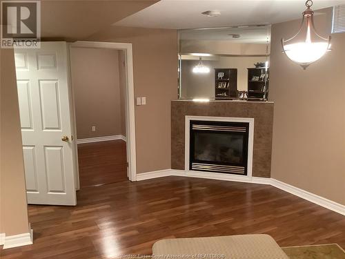 11944 Cobblestone Crescent, Windsor, ON - Indoor Photo Showing Living Room With Fireplace