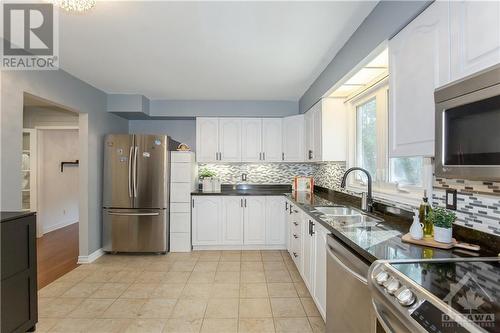 Kitchen with Granite Counter-top, Backsplash & SS Appliances - 240 Equestrian Drive, Ottawa, ON - Indoor Photo Showing Kitchen With Double Sink With Upgraded Kitchen