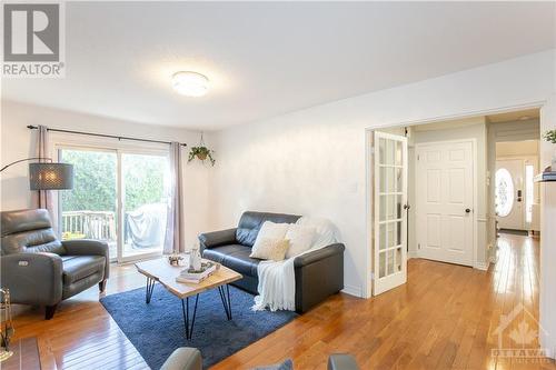 Family Room with Fireplace & Patio Door - 240 Equestrian Drive, Ottawa, ON - Indoor Photo Showing Living Room