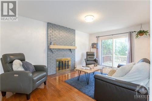 Family Room with Fireplace & Patio Door - 240 Equestrian Drive, Ottawa, ON - Indoor Photo Showing Living Room With Fireplace