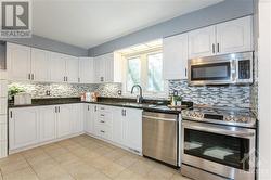 Kitchen with Granite Counter-top, Backsplash & SS Appliances - 