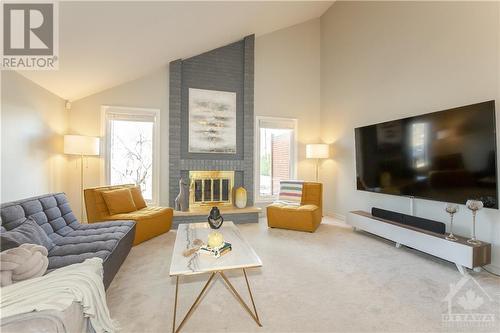 Living Room with Stylish Fireplace & Cathedral Ceiling - 240 Equestrian Drive, Ottawa, ON - Indoor Photo Showing Living Room With Fireplace