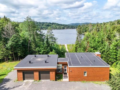 Frontage - 52  - 52A Rue Du Lac-Walfred N., Sainte-Marguerite-Du-Lac-Masson, QC - Outdoor With Body Of Water